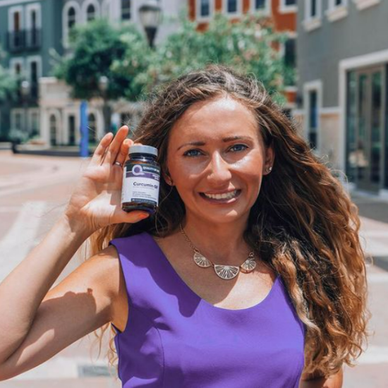 Adriana holding Quality of Life supplements
