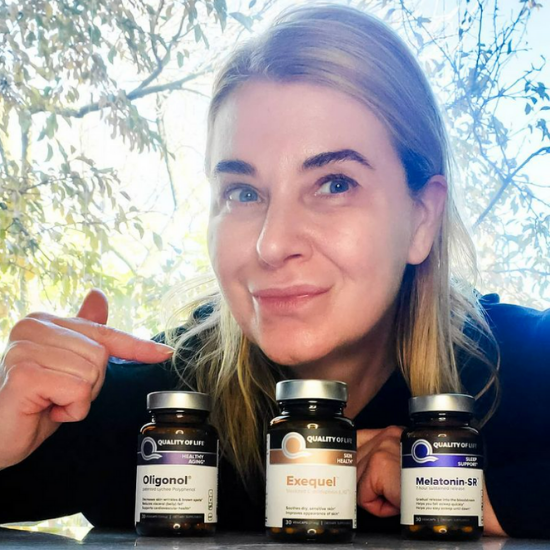 Renata holding Quality of Life supplements